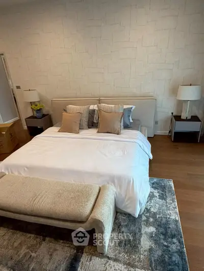 Luxurious bedroom with elegant decor and plush bedding in a modern home.