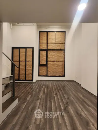 Spacious modern interior with wooden flooring and large windows