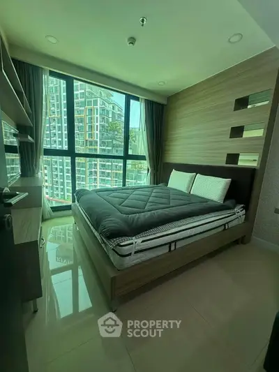 Modern bedroom with large windows and city view in a stylish apartment