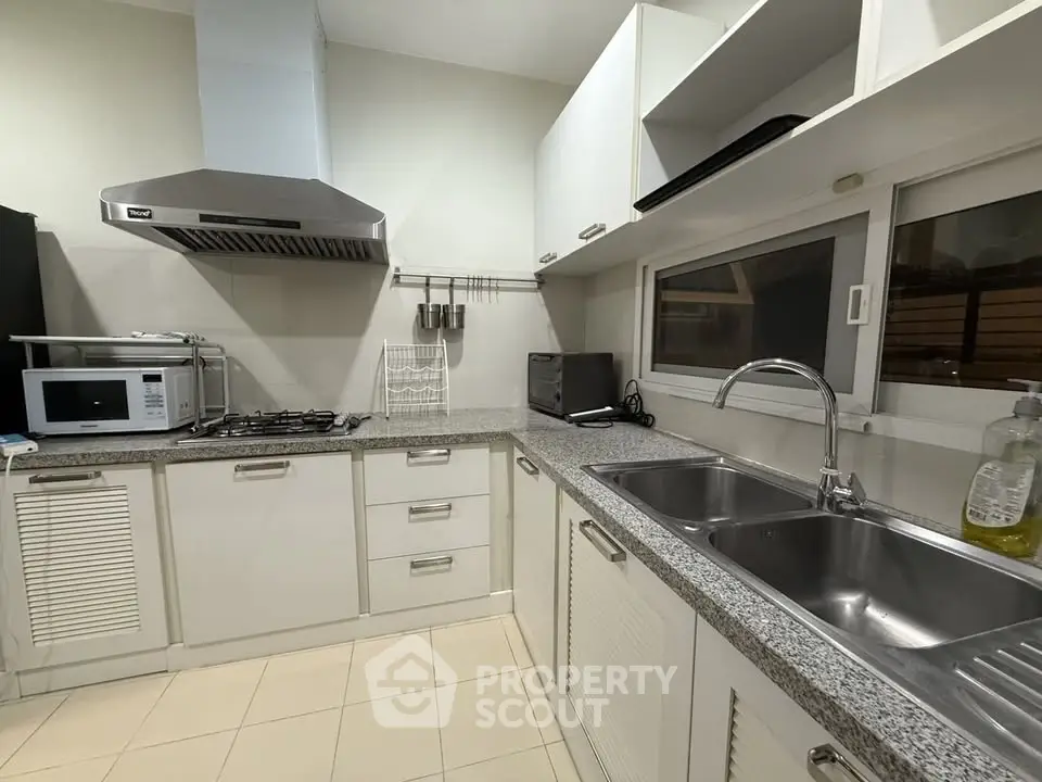 Modern kitchen with sleek cabinets and stainless steel appliances