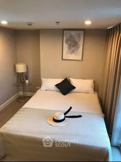 Cozy bedroom with modern decor and soft lighting, perfect for relaxation.