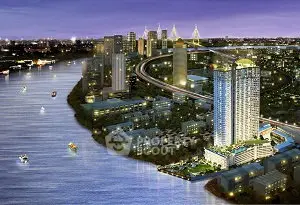 Stunning riverside high-rise building with panoramic city views at night.