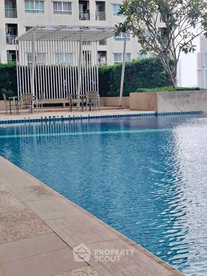 Luxurious apartment poolside with modern pergola and seating area