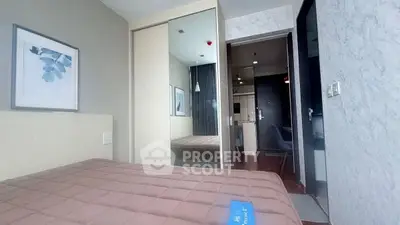 Modern bedroom with stylish decor and sliding closet doors in a contemporary apartment.