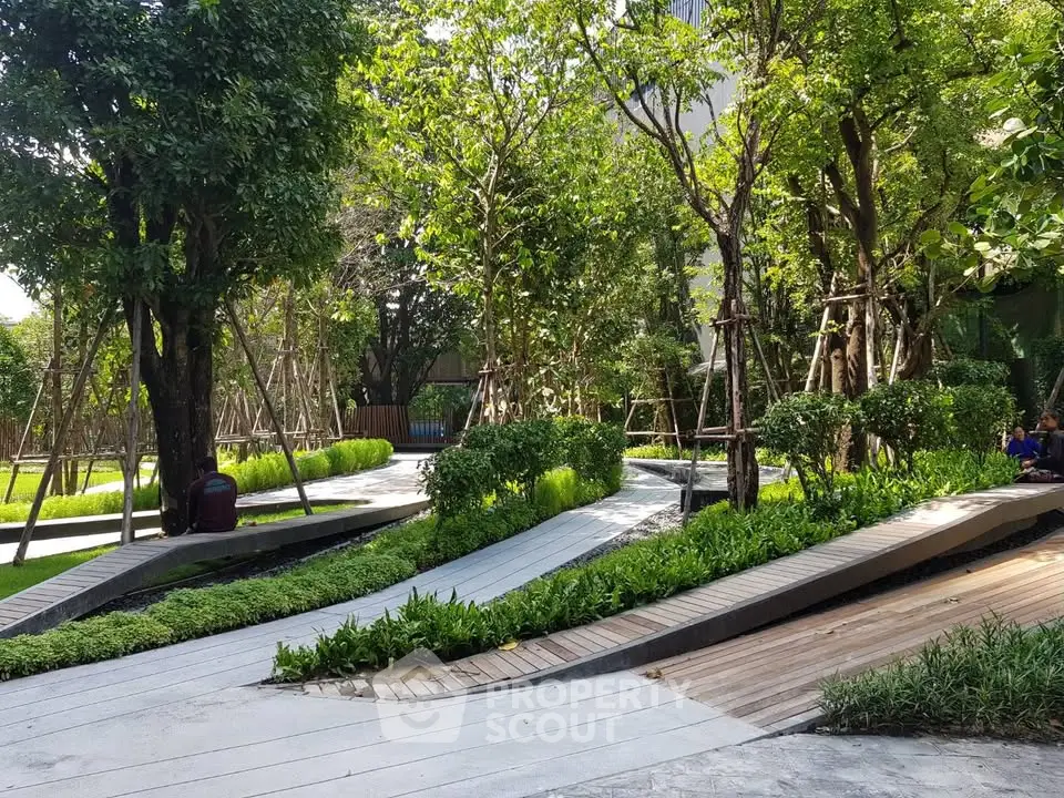 Lush garden area with modern pathways in a residential complex, perfect for relaxation and outdoor activities.