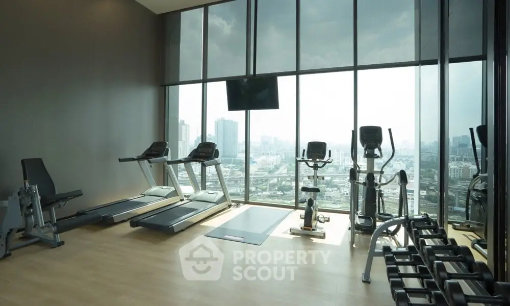 Modern gym with city view and state-of-the-art equipment