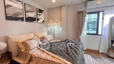 Luxurious bedroom with elegant decor and cozy bedding in modern apartment.