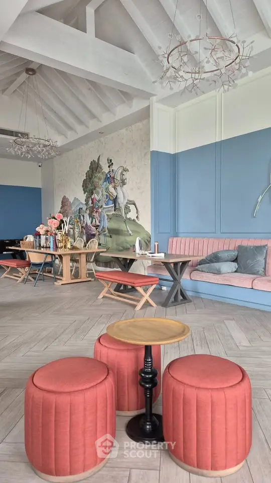 Chic and spacious living room with elegant decor and unique wall art, perfect for stylish gatherings.