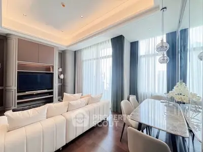 Luxurious living room with elegant decor, high ceilings, and large windows for natural light.