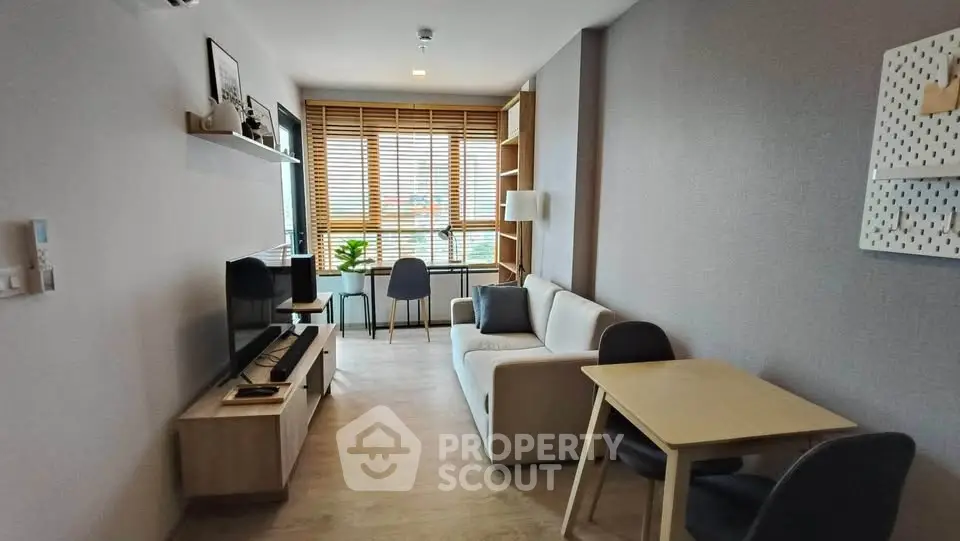 Modern living room with natural light, cozy sofa, and stylish decor in a contemporary apartment.