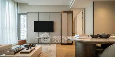 Luxurious modern living room with sleek TV setup and elegant decor in high-rise apartment.