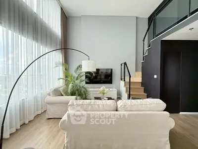 Modern living room with high ceilings and stylish decor