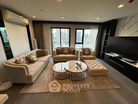 Luxurious living room with elegant sofas, modern decor, and city view windows in a high-rise apartment.