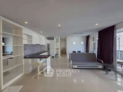 Spacious modern living room with open kitchen and sleek furnishings