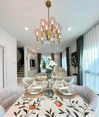 Elegant dining room with stylish chandelier and floral table setting in modern home