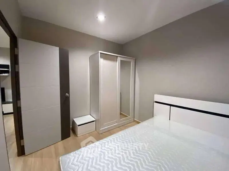 Modern bedroom with sleek white furniture and minimalist design