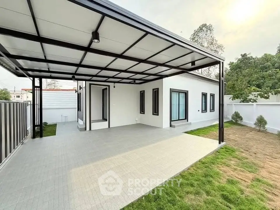 Modern single-story home with spacious covered patio and lush green lawn.