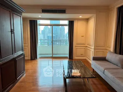Spacious living room with elegant decor and city view balcony in luxury apartment.