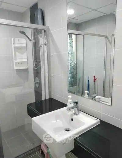 Modern bathroom with sleek sink and glass shower enclosure