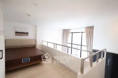 Modern loft bedroom with large window and minimalist decor