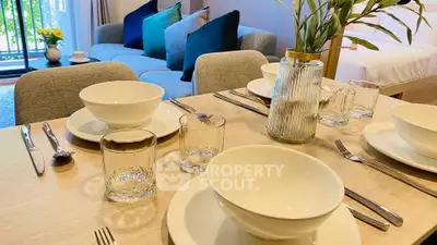Elegant dining setup in modern living room with cozy sofa and balcony view.