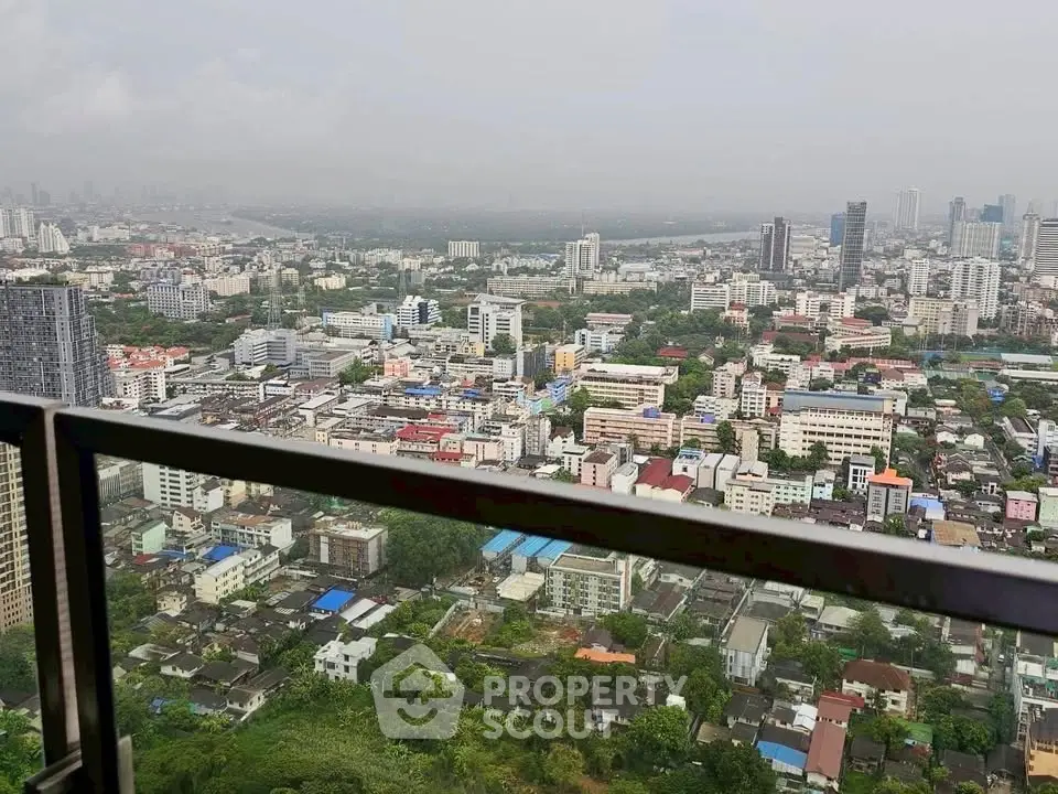 Stunning cityscape view from a high-rise balcony overlooking urban skyline and lush greenery.