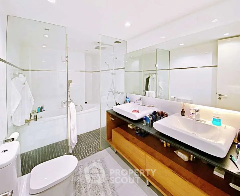 Luxurious modern bathroom with dual sinks and glass-enclosed shower