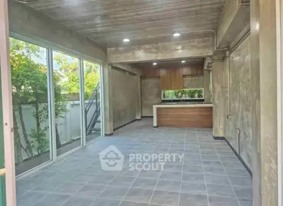Spacious modern living room with open kitchen and large windows