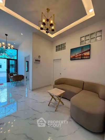 Modern living room with elegant chandelier and stylish furniture in a contemporary home.