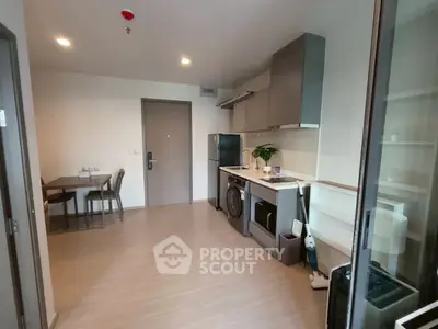 Modern apartment kitchen with sleek appliances and dining area