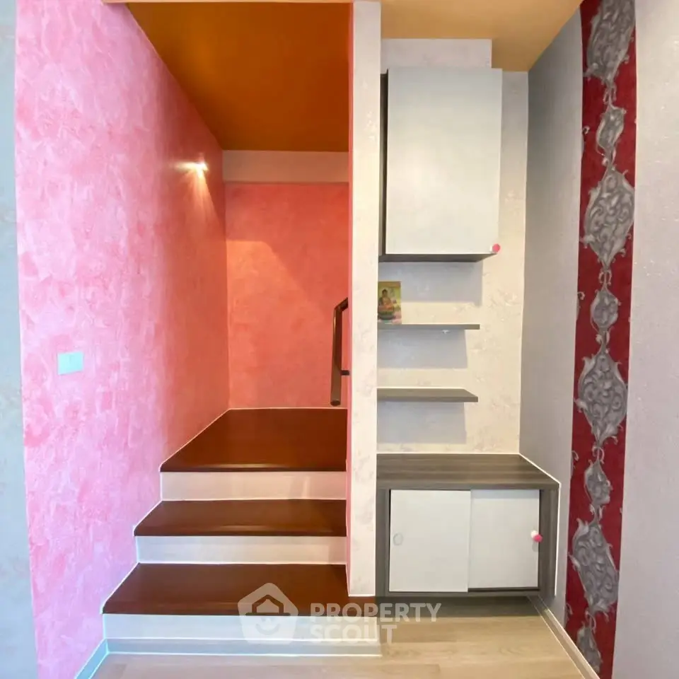 Stylish modern staircase with vibrant colors and built-in storage solutions.