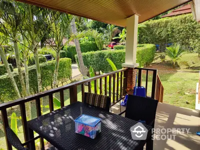 Charming garden view from cozy balcony with outdoor seating