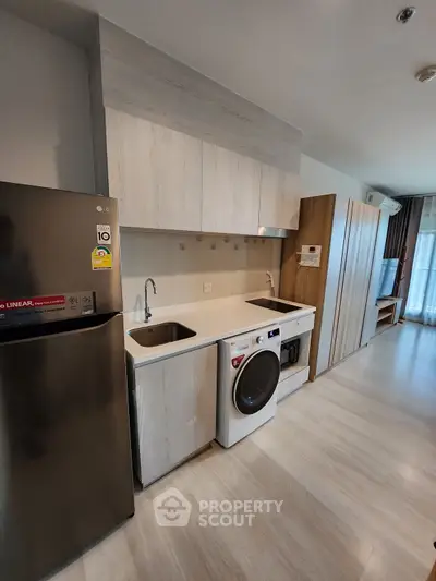 Modern kitchen with sleek appliances and open layout in a stylish apartment