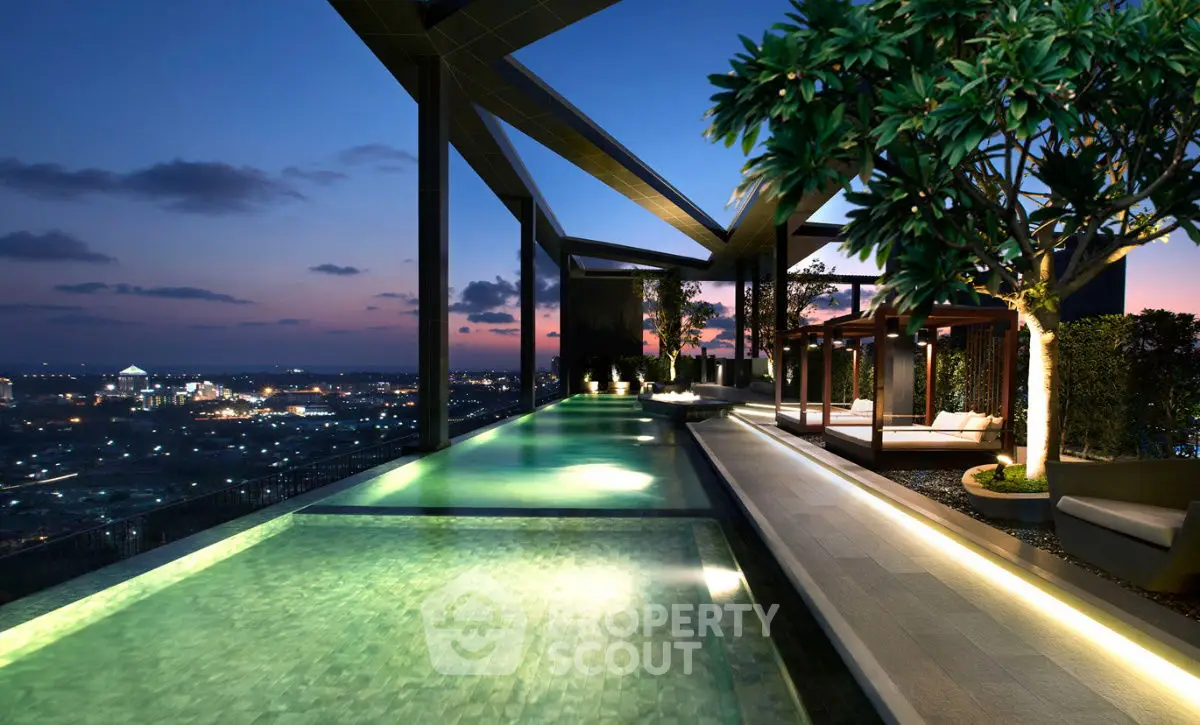 Luxurious rooftop pool with stunning city skyline view at sunset, featuring elegant design and lush greenery.