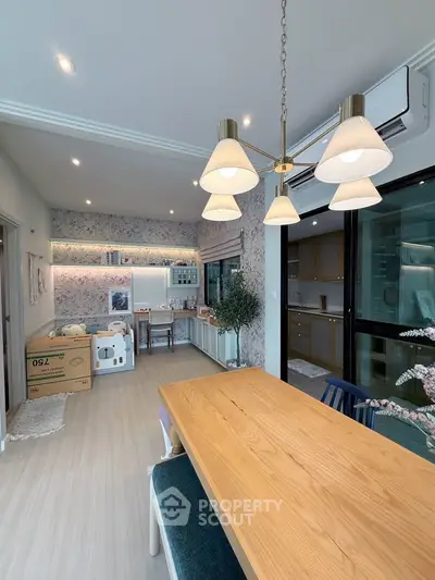 Modern dining area with elegant lighting and stylish decor in a contemporary apartment.