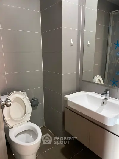 Modern bathroom with sleek gray tiles and contemporary fixtures