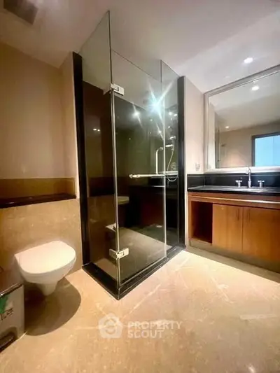 Luxurious modern bathroom with glass shower and elegant fixtures