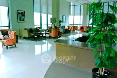 Spacious and elegant living room with modern decor and large windows.