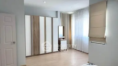 Spacious bedroom with modern wardrobe and natural light