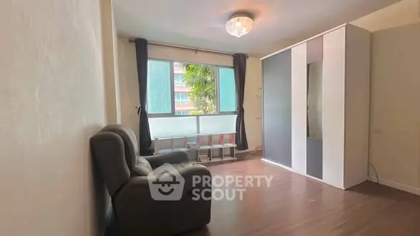 Spacious living room with modern decor and large window view