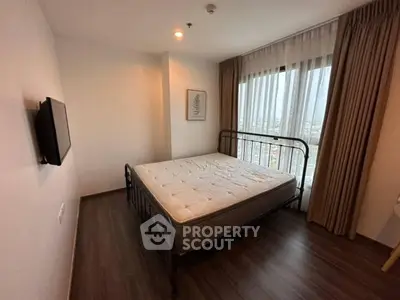 Cozy bedroom with large window and modern decor in urban apartment