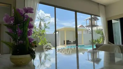 Luxurious living room with pool view and elegant decor, perfect for relaxation and entertaining.