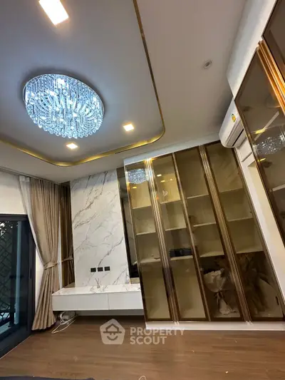 Luxurious living room with elegant chandelier and modern built-in cabinets