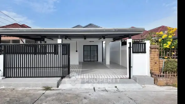 Charming single-story home with gated entrance and tiled driveway in a serene neighborhood.