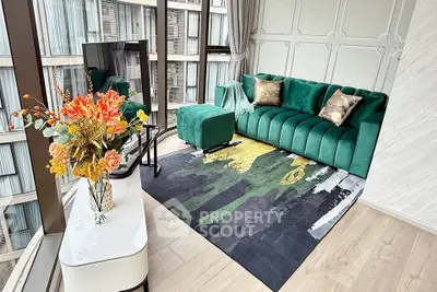 Luxurious living room with green velvet sofa and floor-to-ceiling windows offering stunning city views.