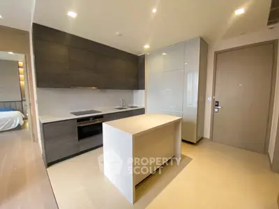 Modern kitchen with sleek cabinetry and island in luxury apartment