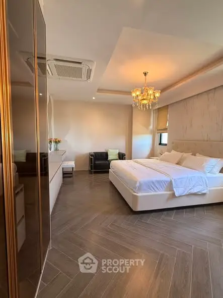Luxurious bedroom with elegant chandelier and modern decor