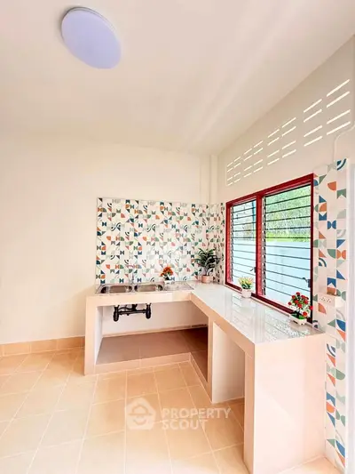 Charming kitchen with colorful tile backsplash and ample counter space