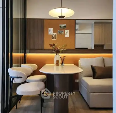 Modern dining area with stylish chairs and cozy sofa in open-plan layout