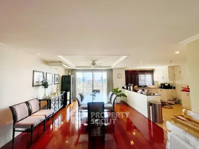 Spacious open-plan living and dining area with city views and modern kitchen.